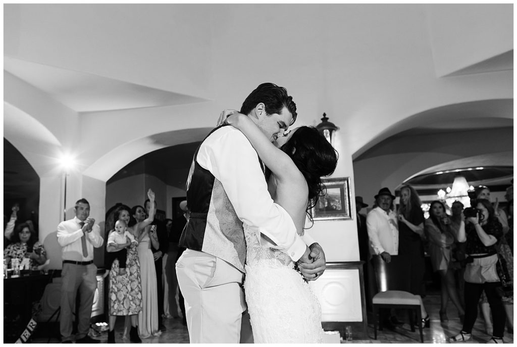 black and white Chateau Carmel Wedding of the couple sharing a kiss surrounded by their family and friends by film photographer AGS Photo Art
