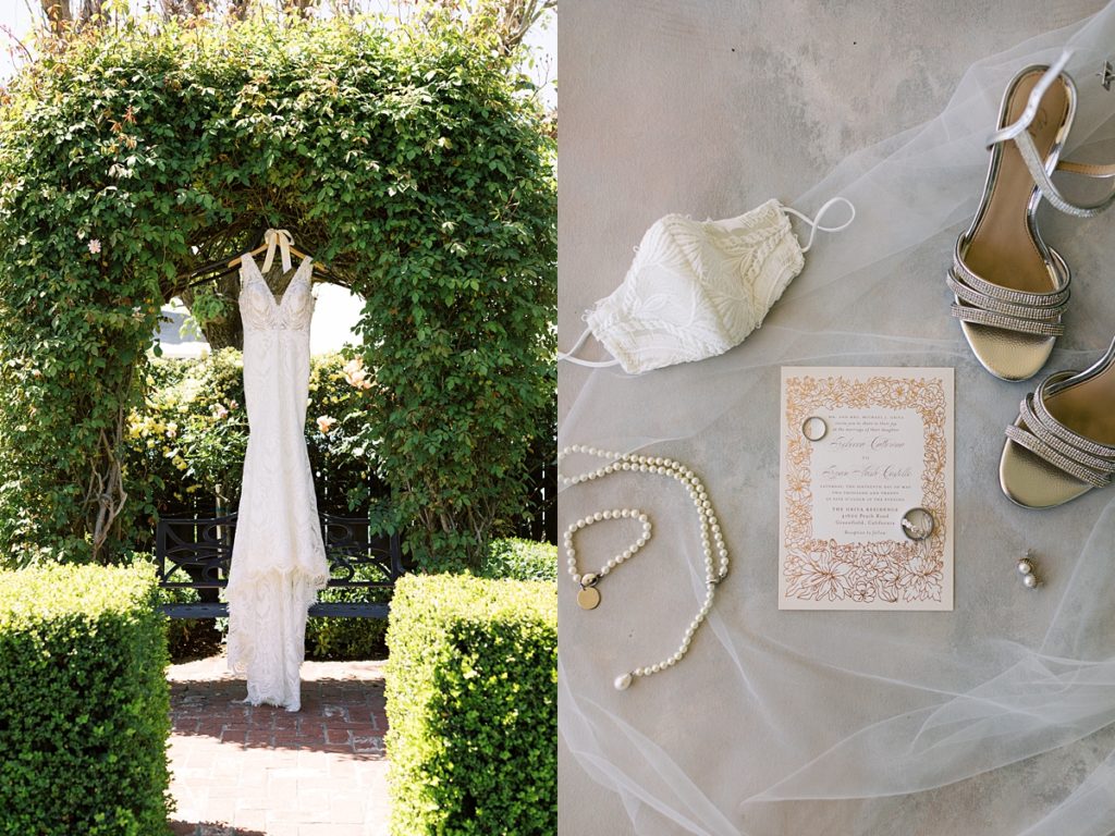 flatlay of Monterey bride wedding details such as pearl jewelry, the invitation suite, and her shoes by Badgley Mischka; photo of the bride's Magnolia by PRONOVIAS wedding dress hanging from an archway made of trees by film photographer AGS Photo Art