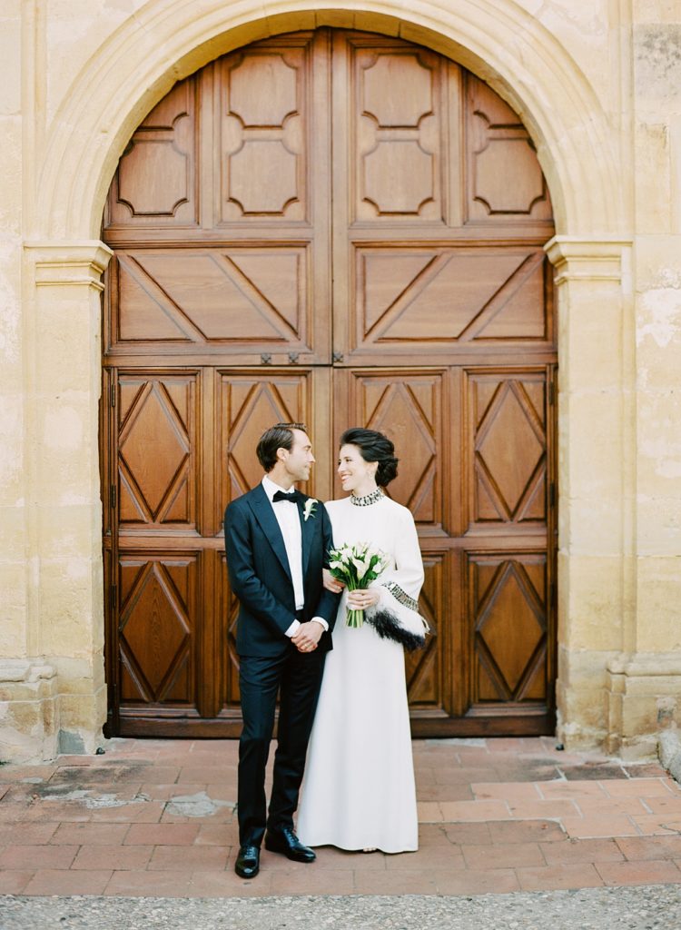 Monterey Peninsula Country Club intimate wedding portrait of the bride and groom in front of an arched doorway