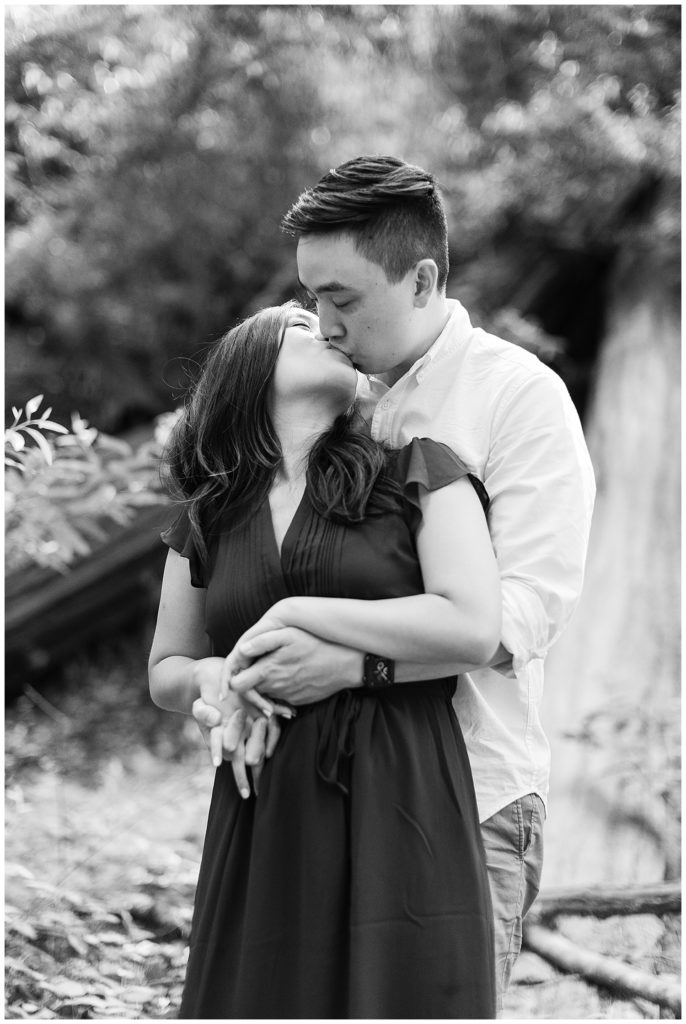 black and white portrait of couple sharing a kiss