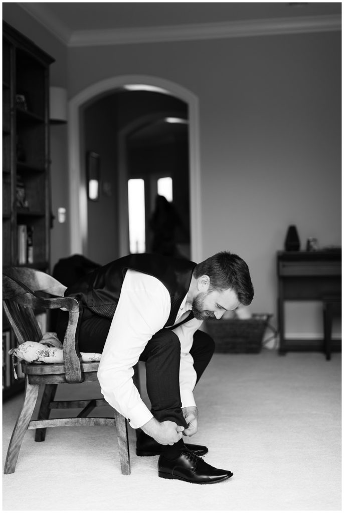 black and white portrait of the groom getting ready by film photographer AGS Photo Art