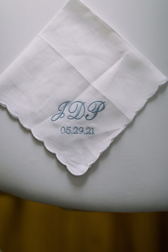 pocket square with the groom's initials and the wedding date