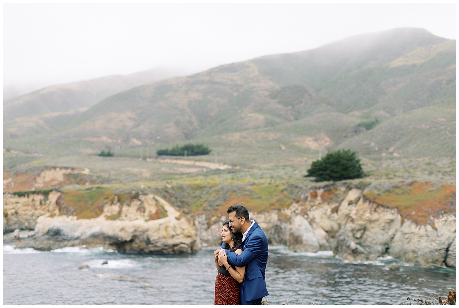 couple overlooking the water in each other's arms