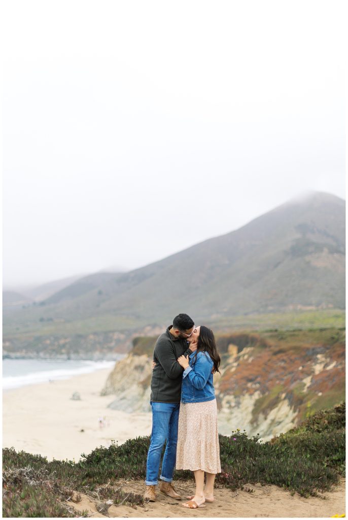 portrait of couple sharing a kiss on the cliffs by Big Sur photographer AGS Photo Art