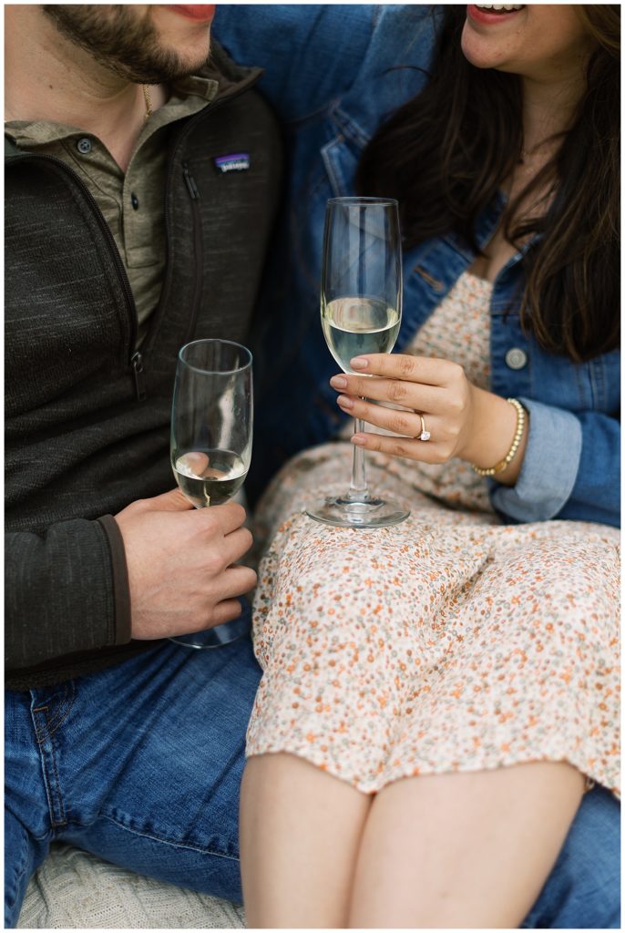 couple sitting together in each other's laps and sharing champagne