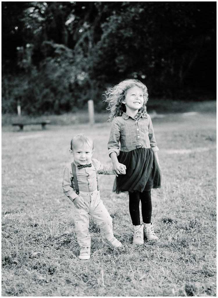 black and white sibling portrait in a field by film photographer AGS Photo Art