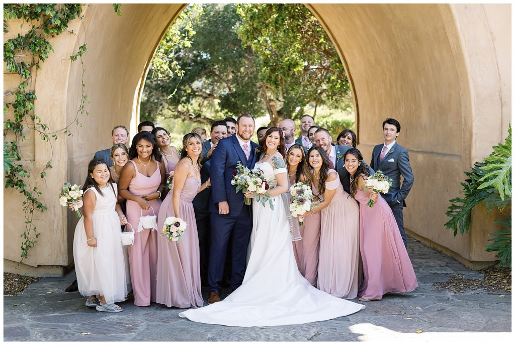 portrait of the bride and groom with all their guests at their Monterey wedding at The Club At Pasadera