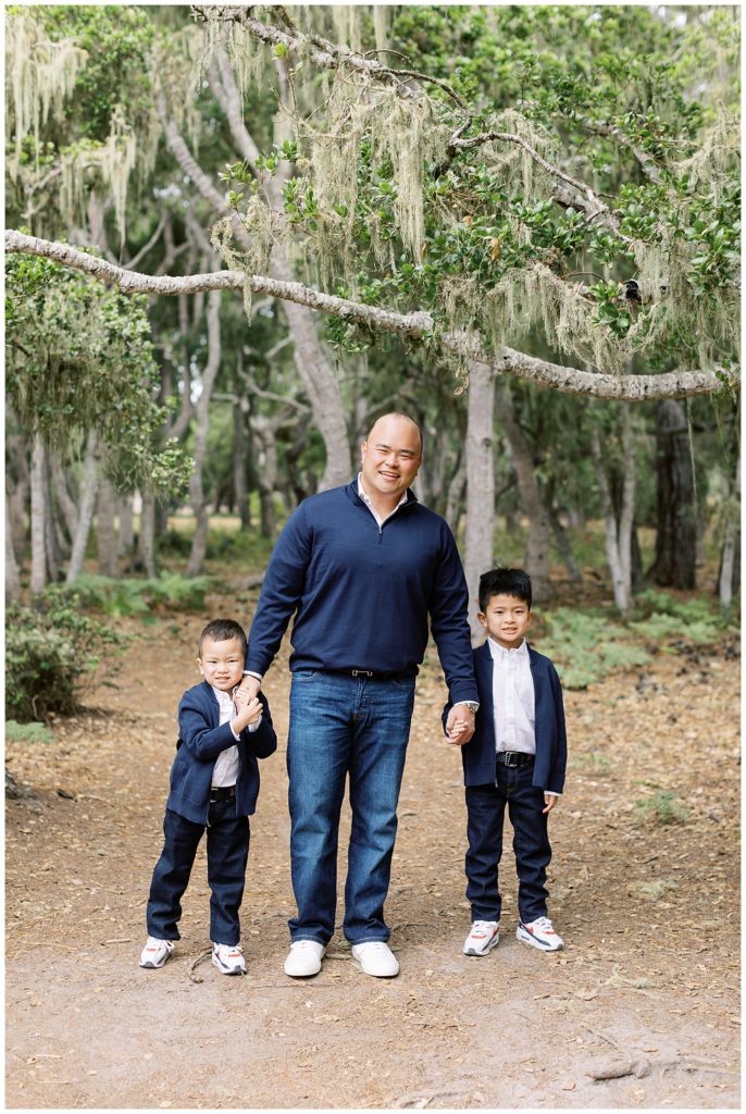portrait of Dad and his two boys all holding hands