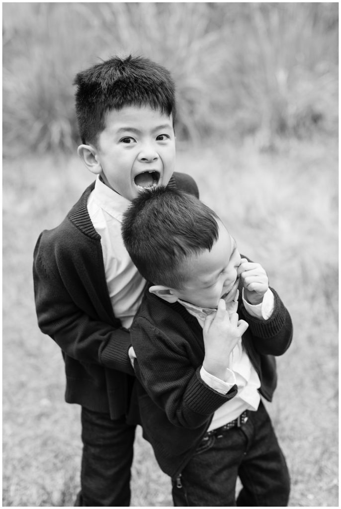 black and white photo of brothers making silly faces
