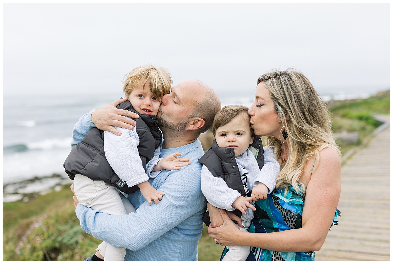 parents kissing their baby boys on their cheeks at Pebble Beach