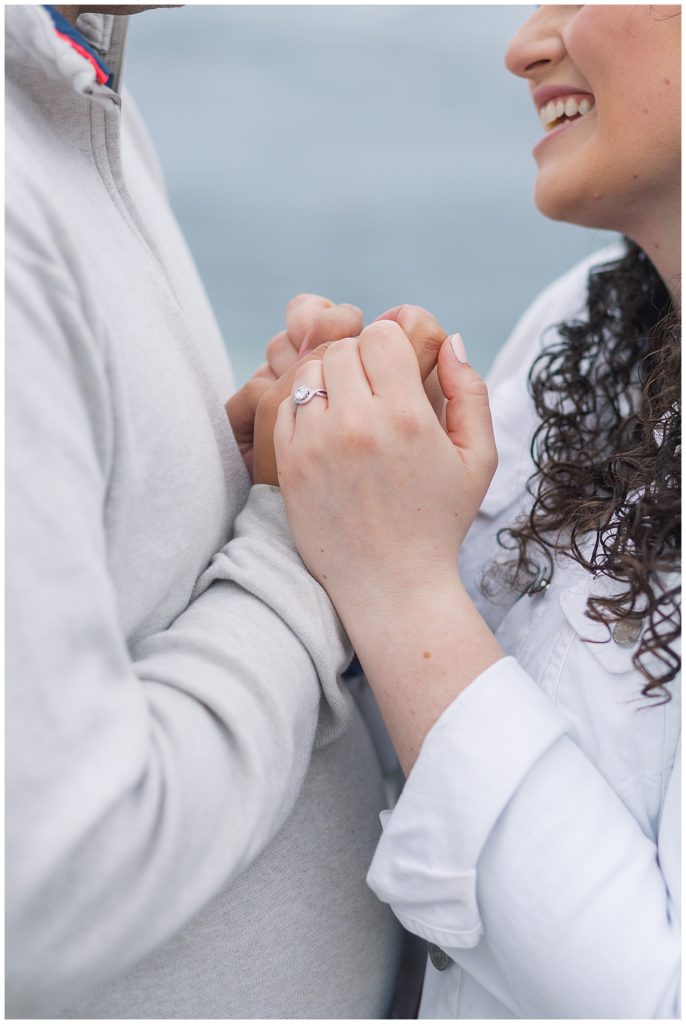 photo of the couple's hands with their Spanish Bay surprise proposal engagement ring