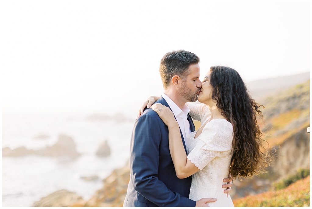 landscape photo of couple sharing a kiss Big Sur Engagement + Bernardus Wedding by film photographer AGS Photo Art