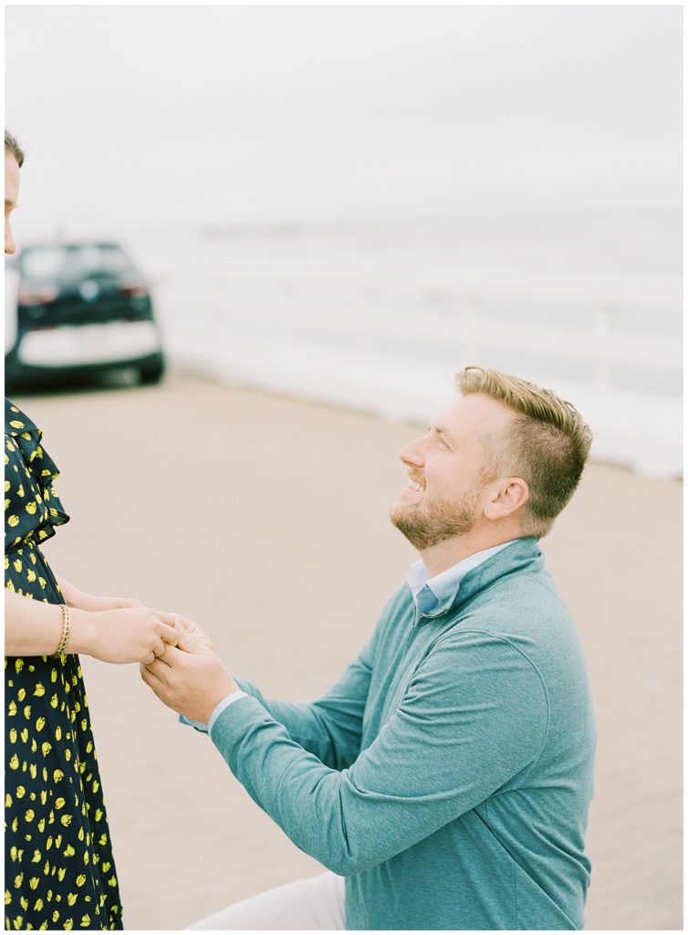surprise proposal on the pier in Pebble Beach