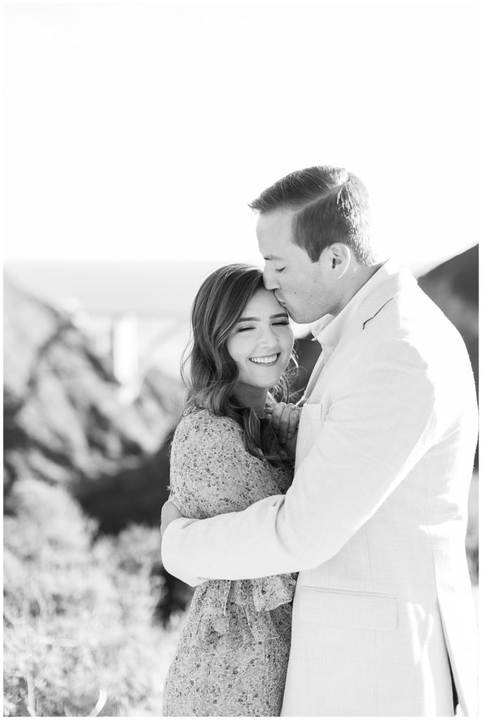 black and white couple portrait from their engagement session in Big Sur with the Bixby Bridge behind them by film photographer AGS Photo Art