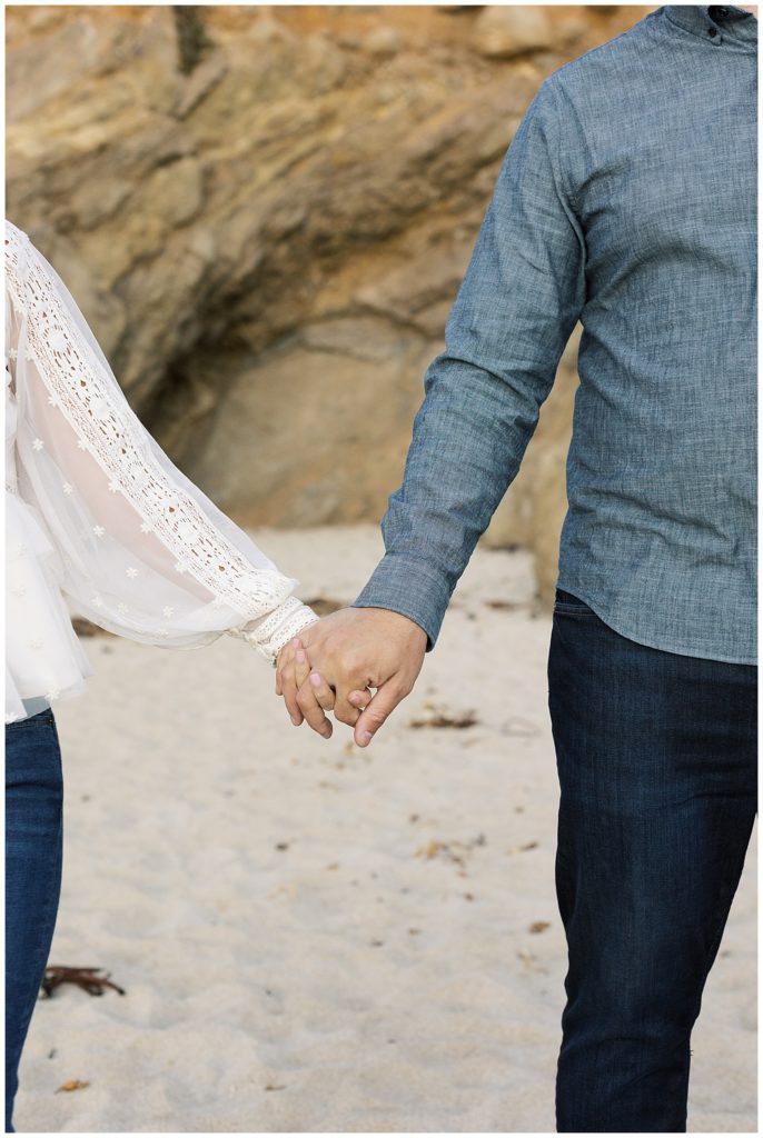couple hand in hand during their engagement session in Big Sur