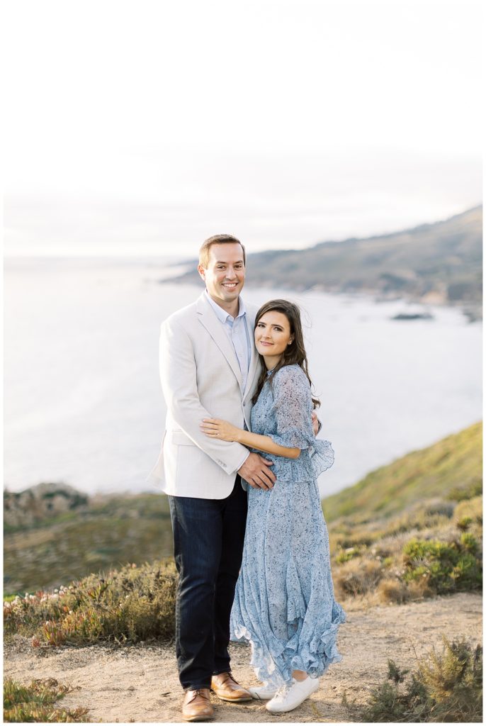 couple portrait with the cliffs and ocean behind them
