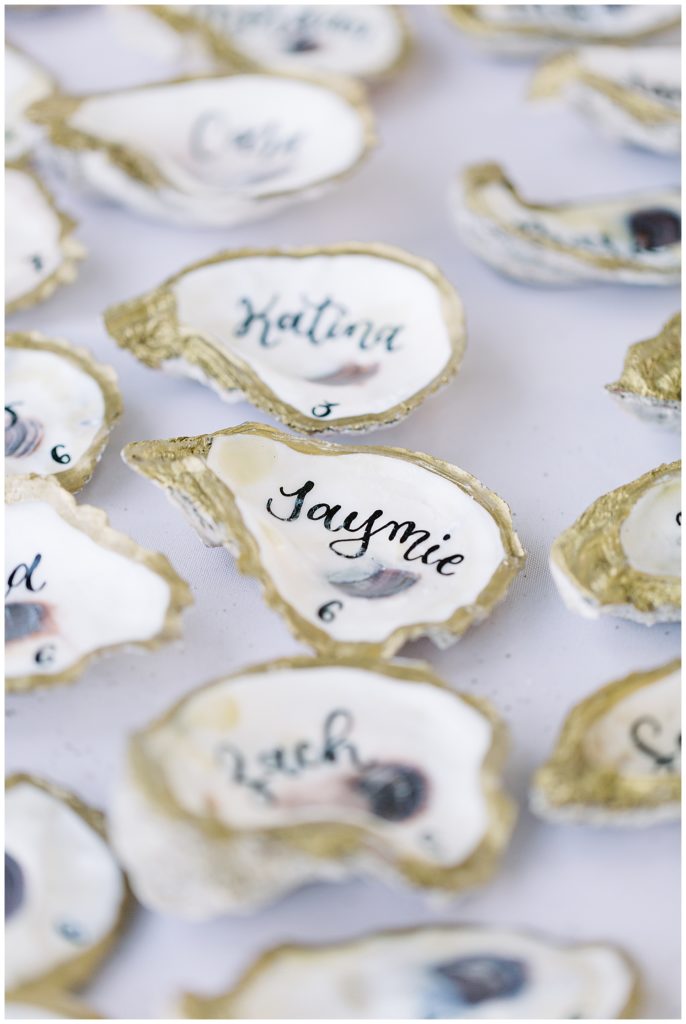 the names of the couple's wedding guests calligraphied onto sea shells