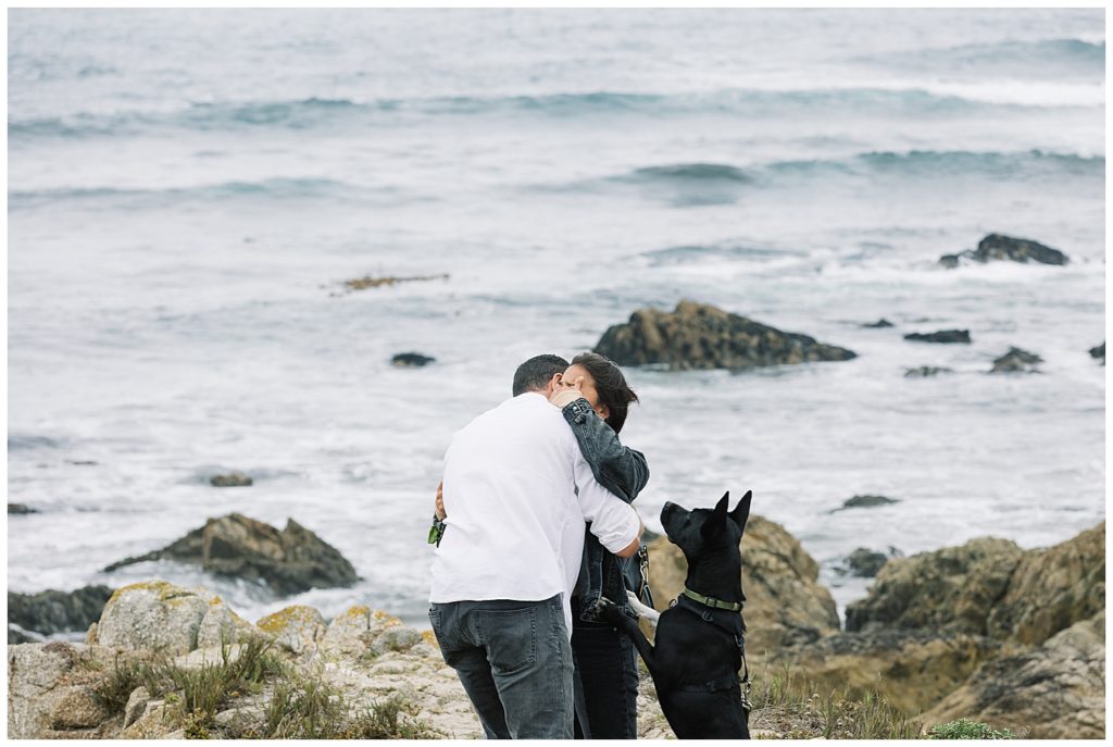 emotional couple at Pebble Beach during their Spanish Bay surprise proposal with their dog by film photographer AGS Photo Art