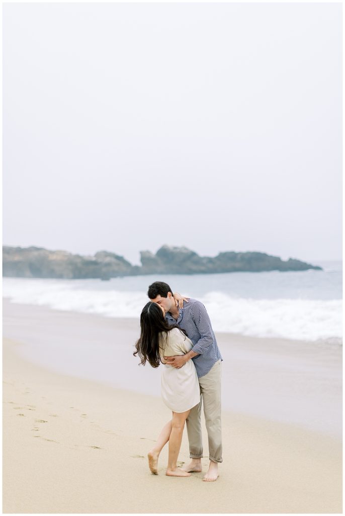 couple sharing a kiss at the beach during their Big Sur engagement shoot