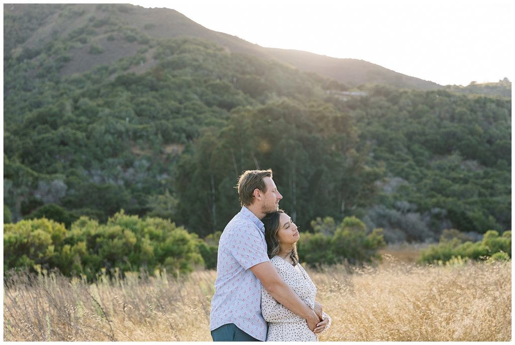 couple in each other's arms enjoying their Carmel Valley engagement session