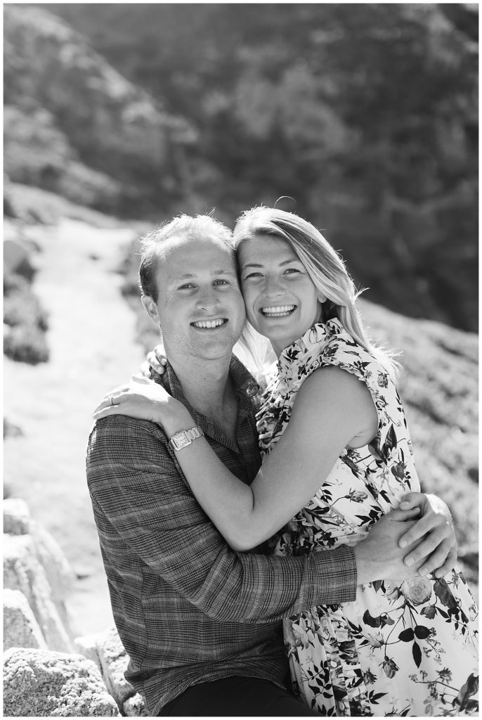 black and white portrait of the couple embracing and smiling at the camera during their Post Ranch Inn surprise proposal