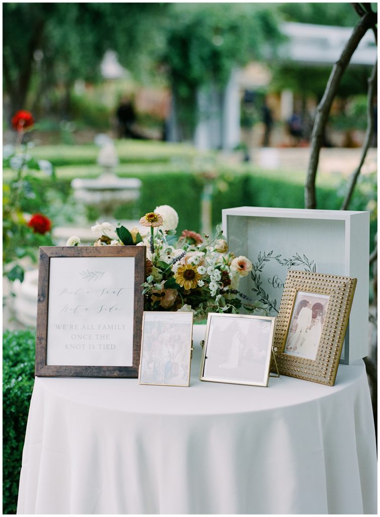 bride and groom's family table with portraits of each person's family members