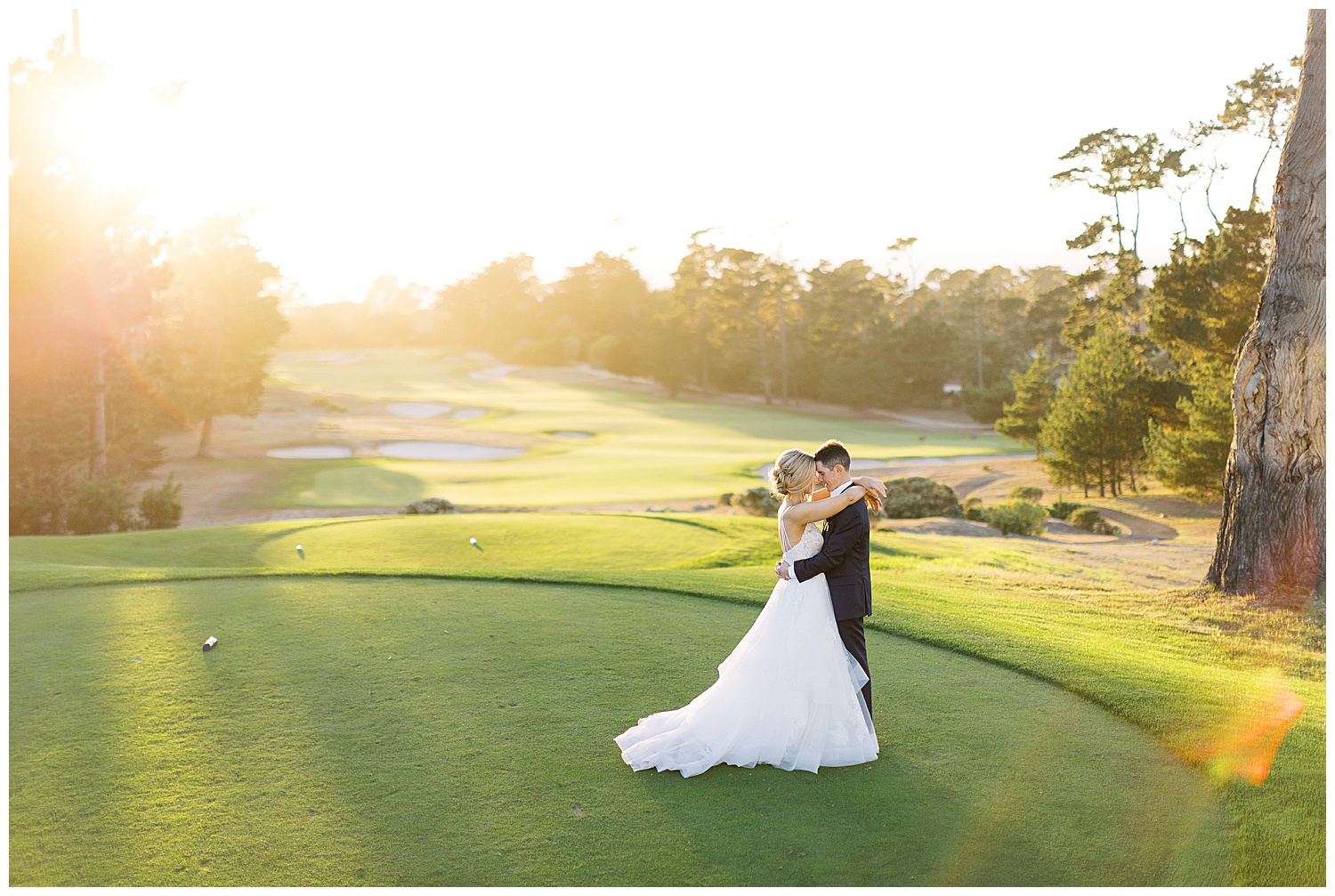 the bride and groom embracing each other at Spyglass Hill Golf Course in Pebble Beach with the sun setting behind them