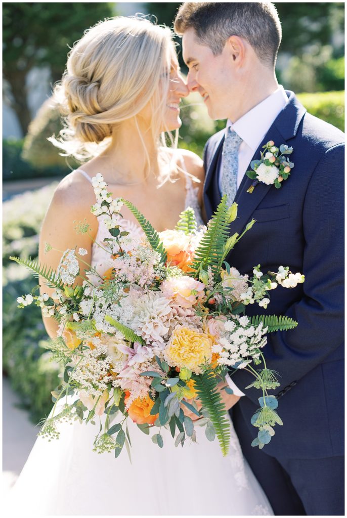 the bride and groom touching their noses together; MPCC luxury wedding flowers by Fleurs du Soleil