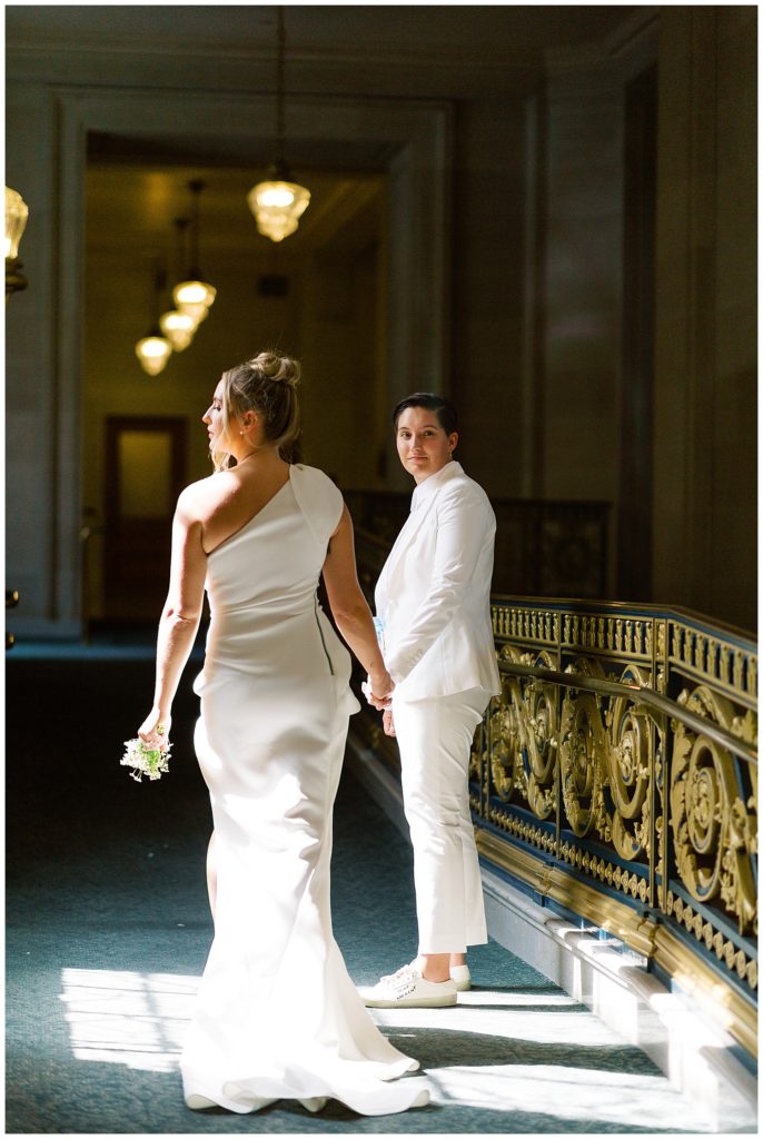 brides walking in the light of a window at San Francisco City Hall