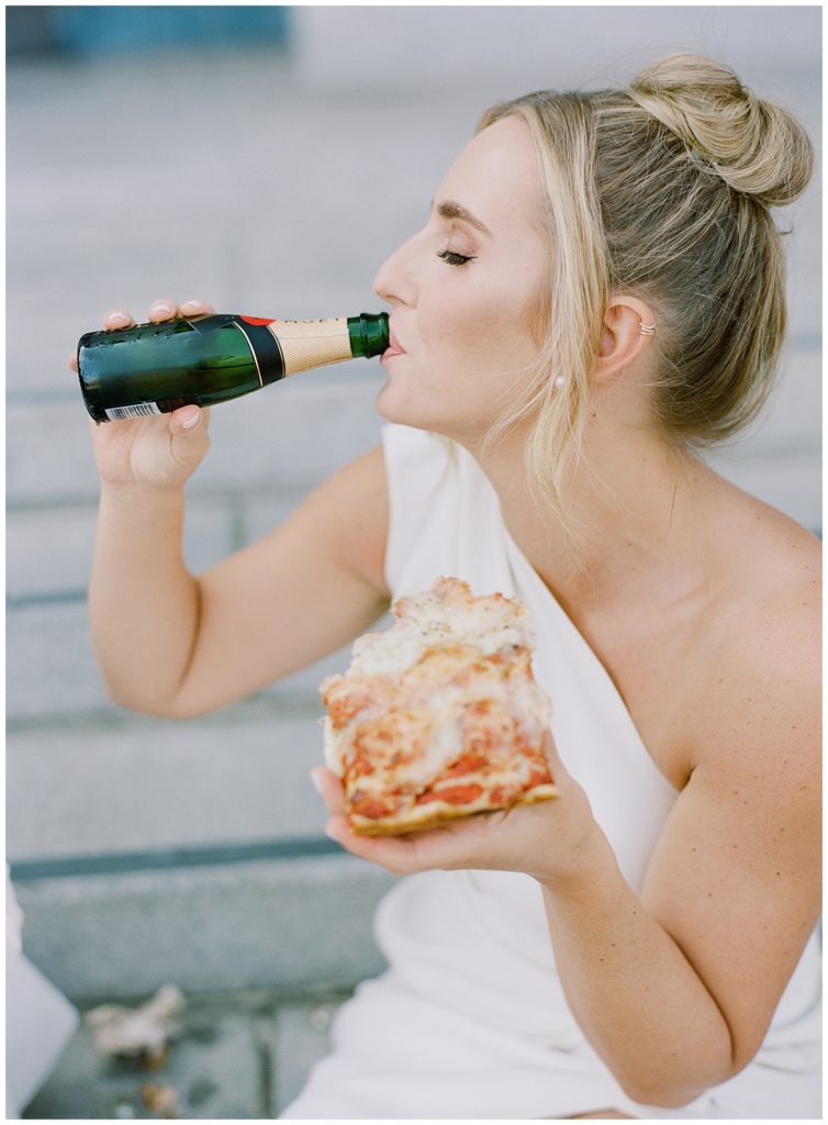 portrait of bride drinking Moet champagne in one hand and holding pizza with the other by film photographer AGS Photo Art