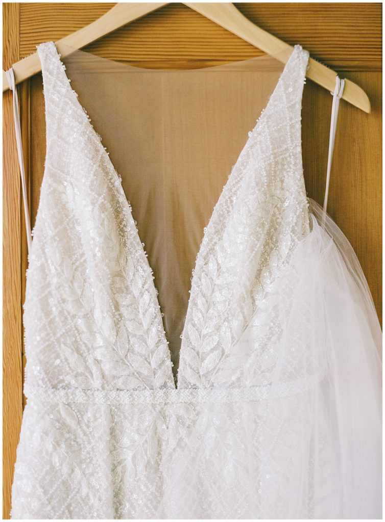 bride's Wind & Sea Estate Big Sur wedding dress by JANE HILL hanging in the door