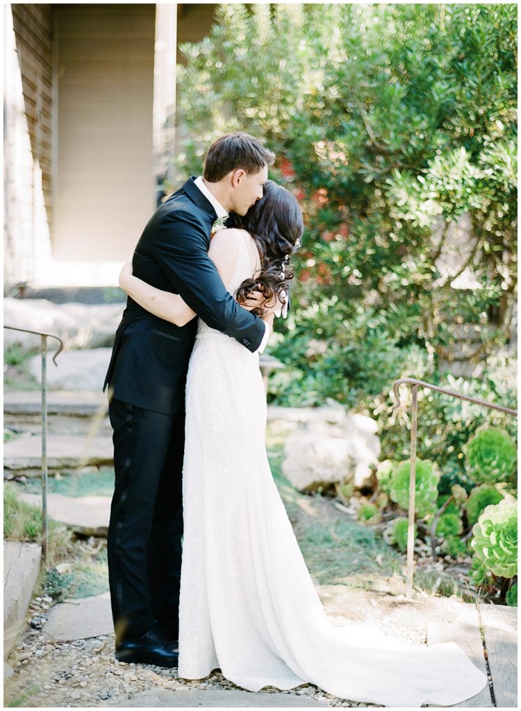 Wind & Sea Estate Big Sur wedding of the couple embracing in the courtyard