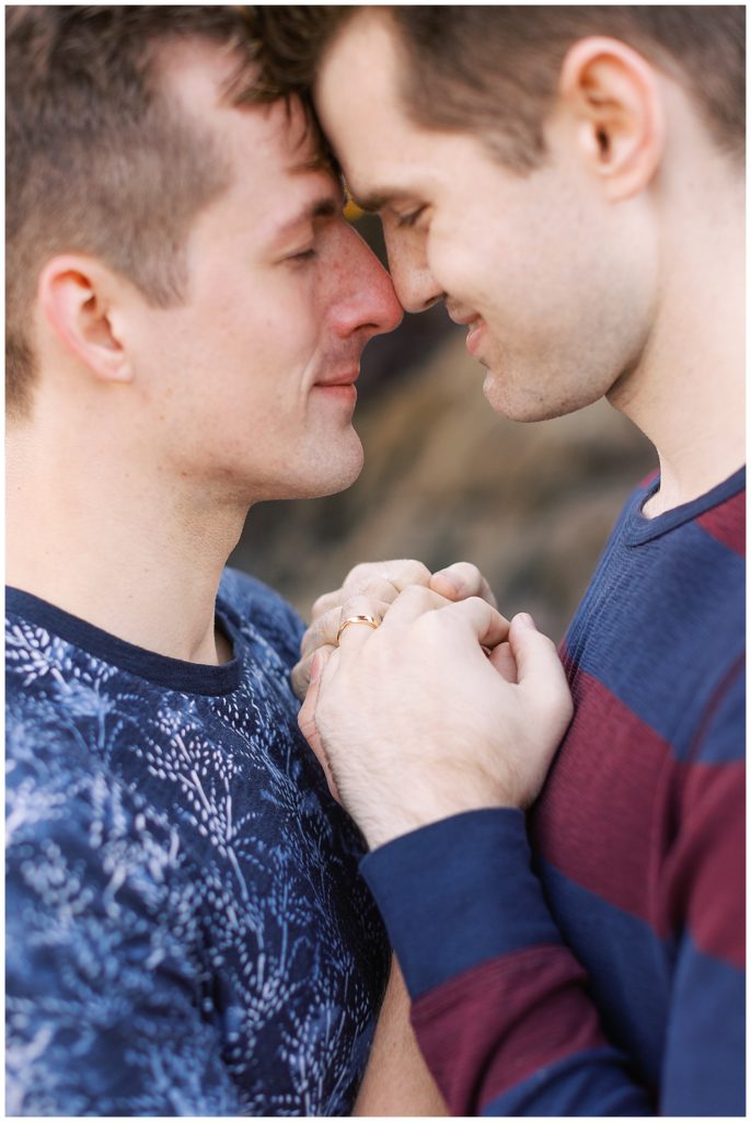 same sex couple embracing and smiling