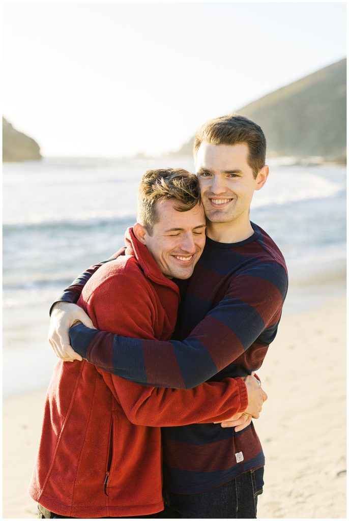 lgbt couple embracing and smiling at the camera