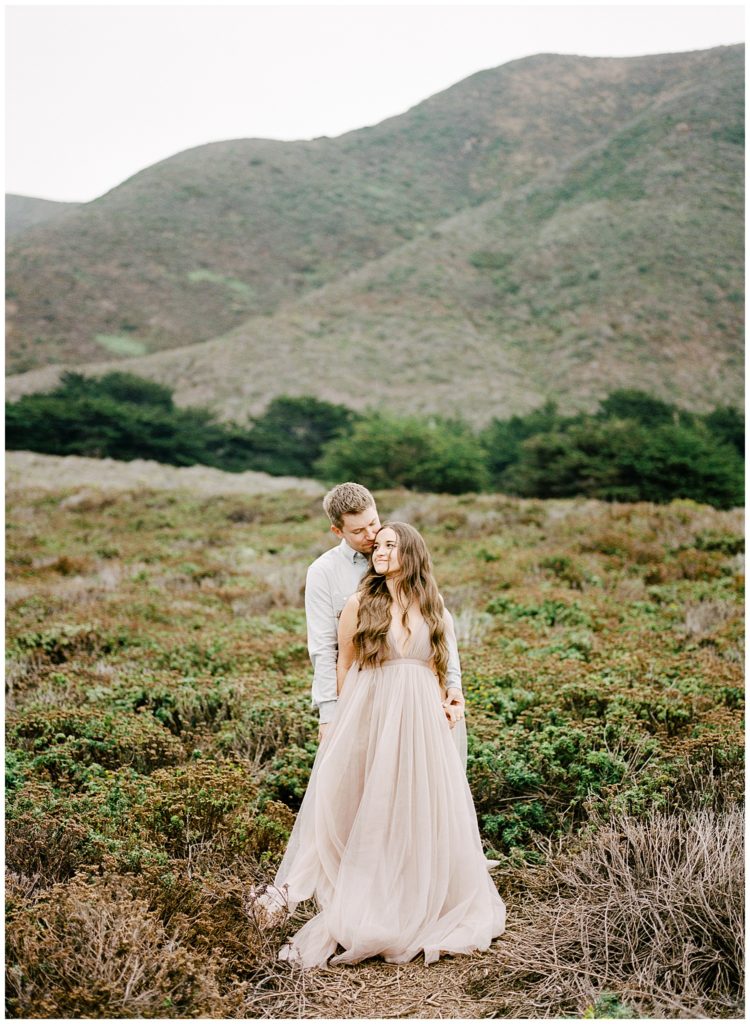 engagement photos in Big Sur fields with the mountains in the background
