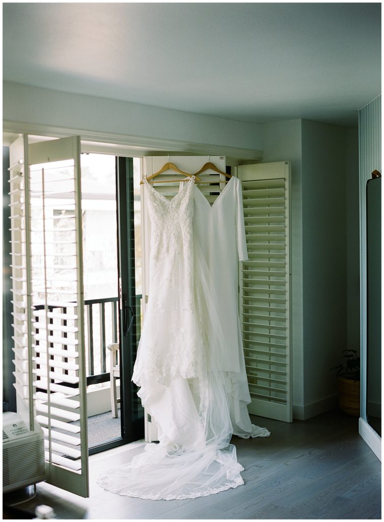 bride's Monterey wedding gowns hanging in the window