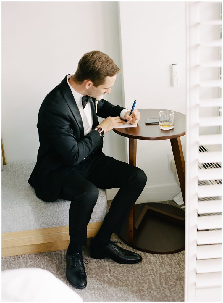 the groom writing his vows for his Monterey wedding in Memory Garden