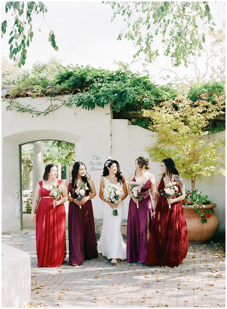 the bride and her bridesmaids walking through Memory Garden
