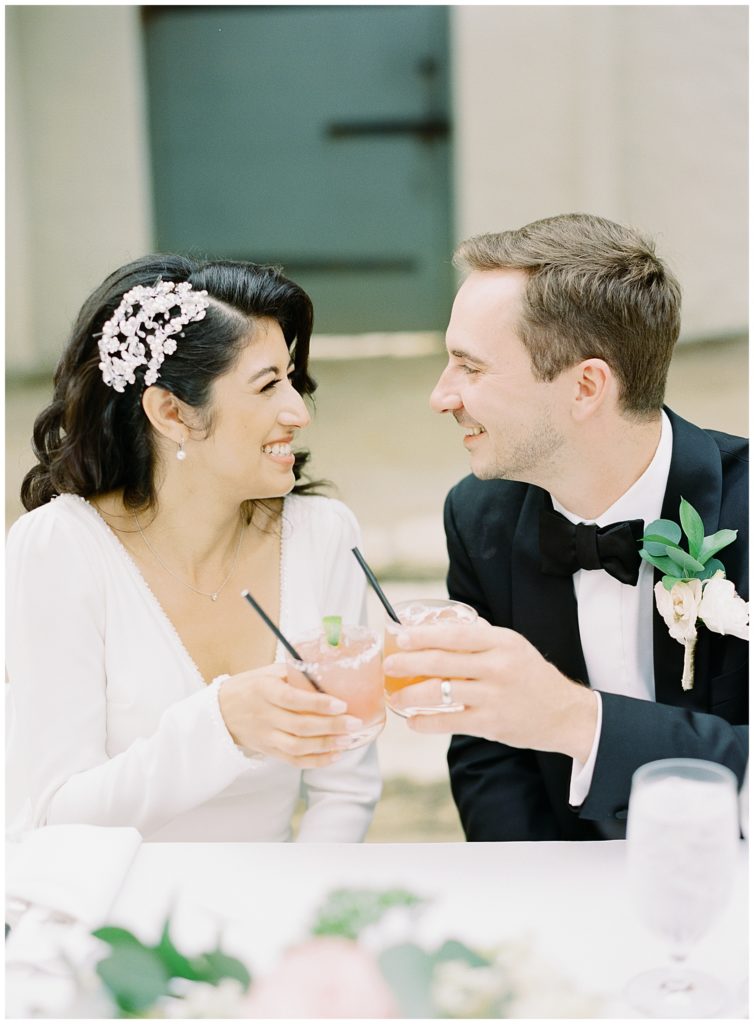 bride and groom toasting their specialty cocktails
