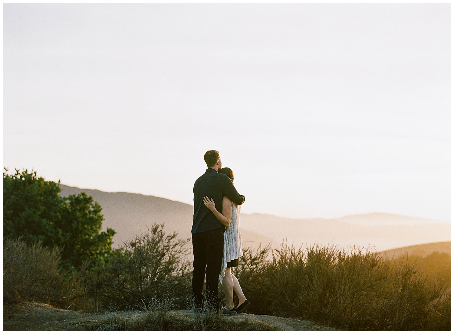 Carmel engagement session landscape photo of the couple looking out at the hills and valleys