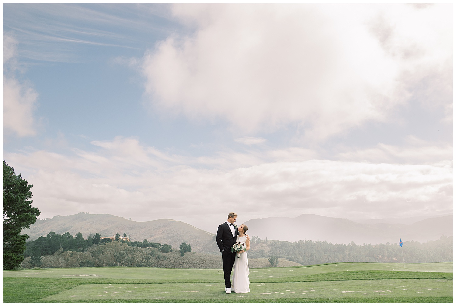 sweeping view of Tehama golf course with the bride and groom in the middle of it all smiling at each other