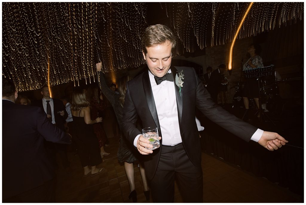 dancing groom with a vodka soda in his hand