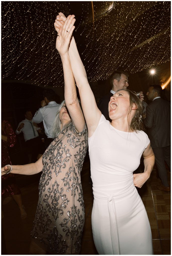 bride and mom dancing the night away
