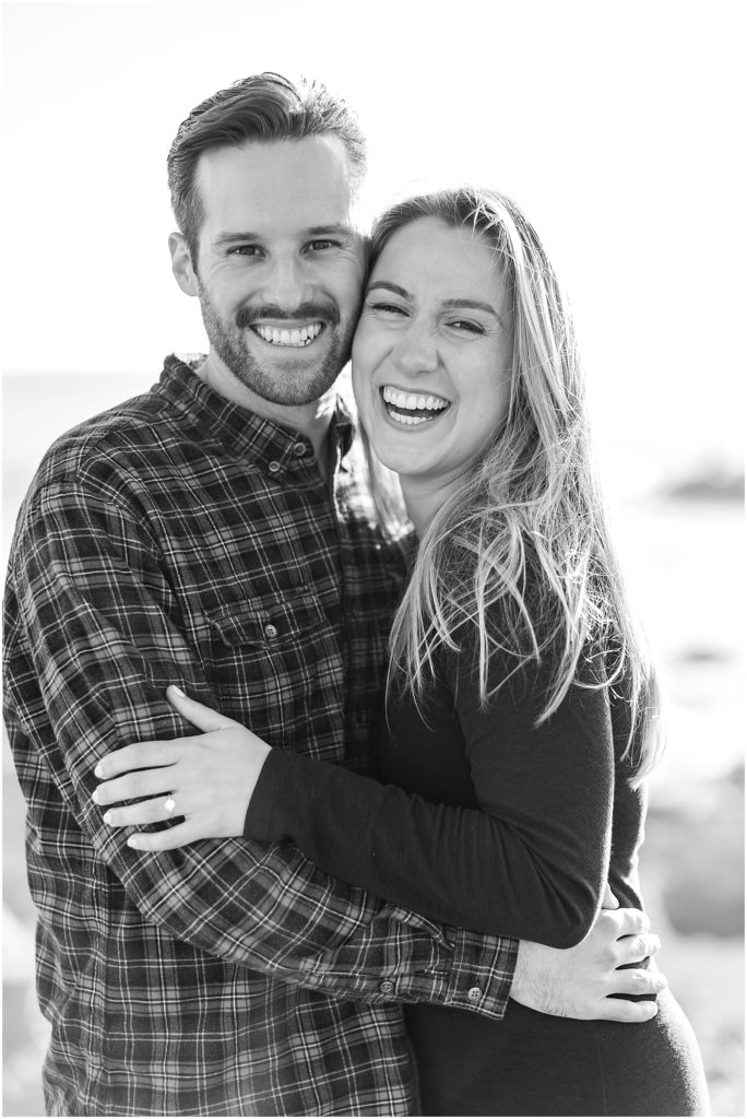 couple holding one another and laughing during Big Sur Engagement Photoshoot