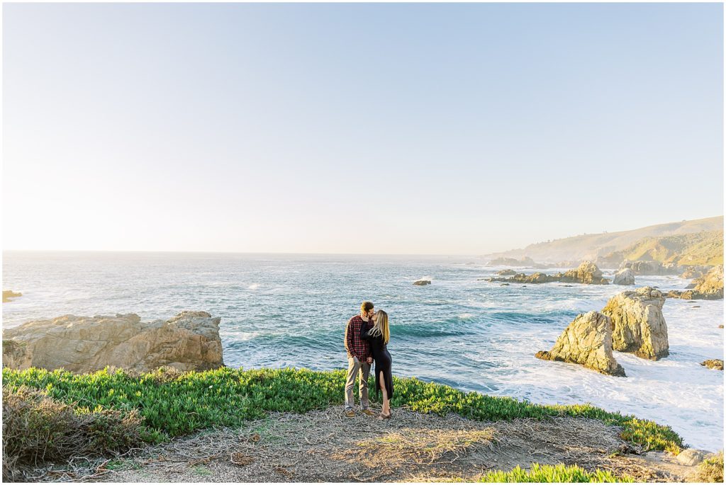 a couple kissing along the coastline of Big Sur for their engagement photoshoot