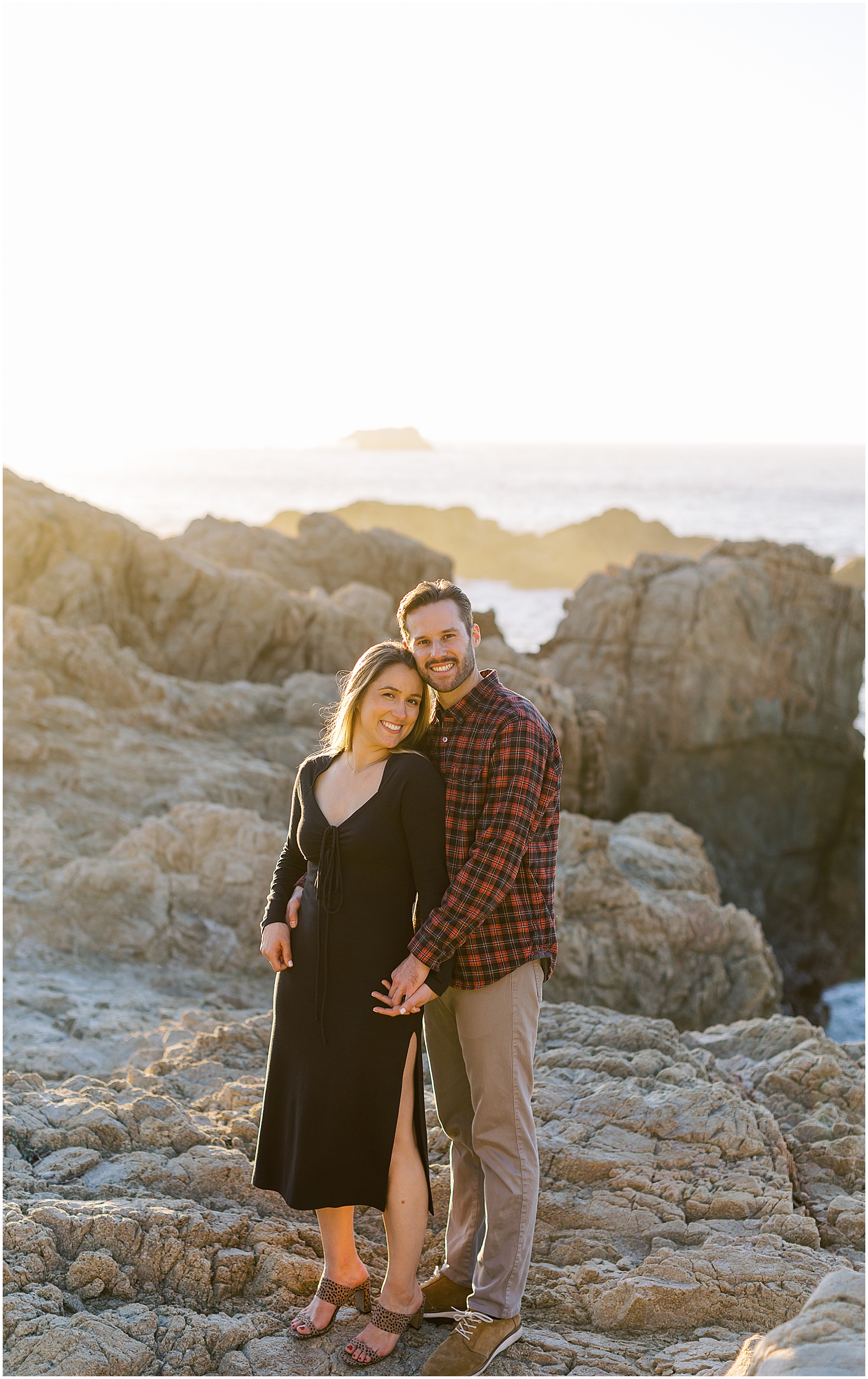 a couple standing together on the rocks down in Big Sur California