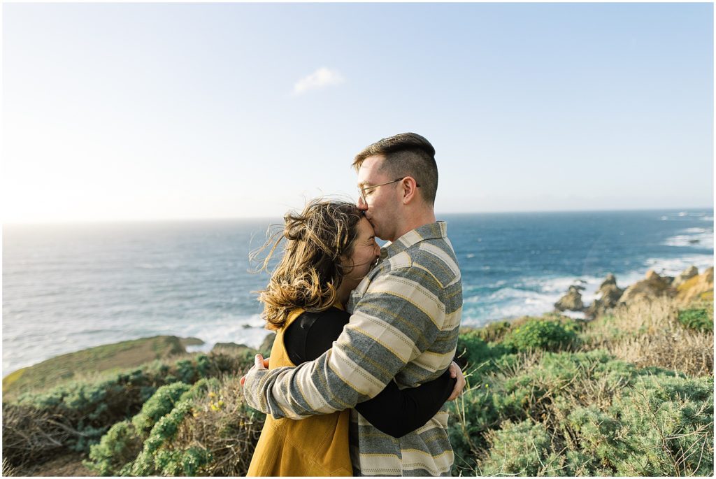 portrait of couple embracing along the coastline of Big Sur