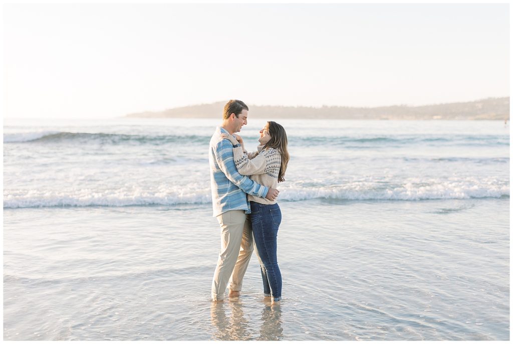 couple standing together in the water during Carmel-By-The-Sea Surprise Proposal 
