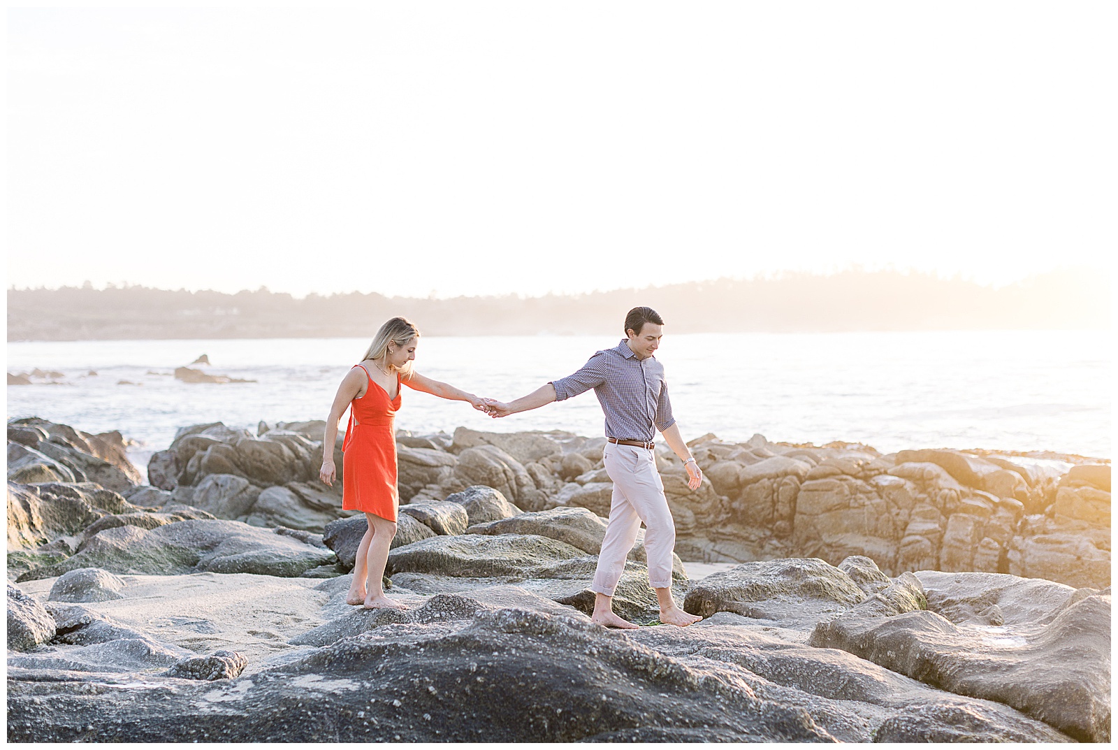 a couple walking along the rocks during Carmel surprise proposal