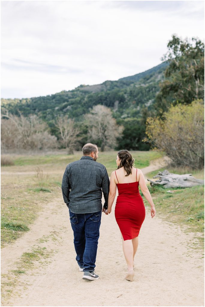 a couple walking holding hands during Carmel Valley Engagement Shoot